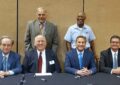 Participants gather to autograph programs after the stamp dedication ceremony. Top, from left: Doug Poindexter, president of the World Pet Association, and Las Vegas Letter Carrier Otis Hembre. Bottom, from left: James Bilbray, chairman of the USPS Board of Governors; Robert Vetere, chairman of the Pet Leadership Council; KSNV-TV host Dana Wagner; and Chief Marketing and Sales Officer James Cochrane.