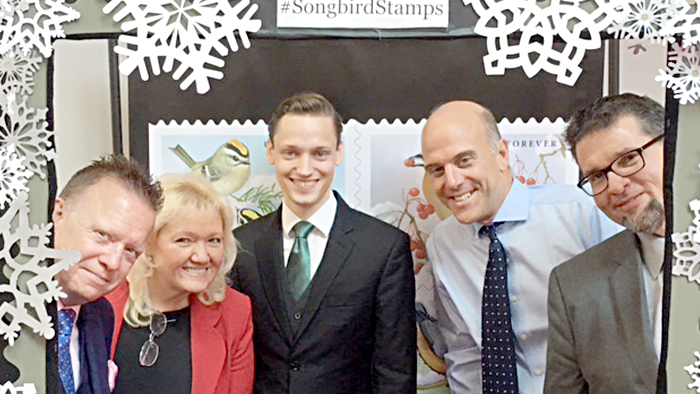 Gathered at the stamp dedication ceremony’s “selfie station” are, from left, Sales VP Cliff Rucker, Stamp Services Director Mary-Anne Penner, philatelist Tim Hodge, Audubon Society of Portland Executive Director Nick Hardigg and American Philatelic Society Executive Director Scott English.