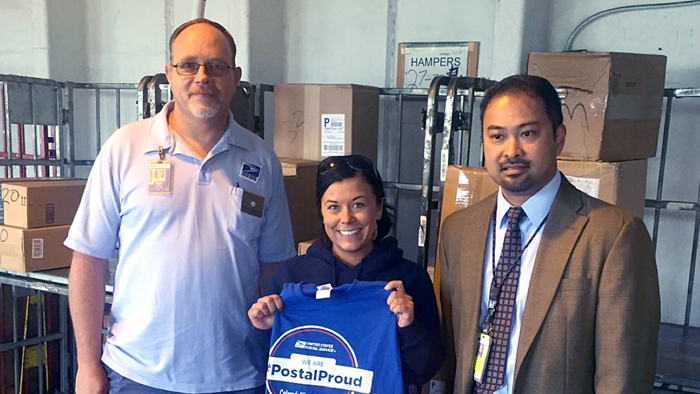 Colorado Springs, CO, City Carrier Assistant Shannon Fager, center, is congratulated by National Association of Letter Carriers Branch 204 President Mark Robbins, left, and Colorado Springs Postmaster Sam Reed.