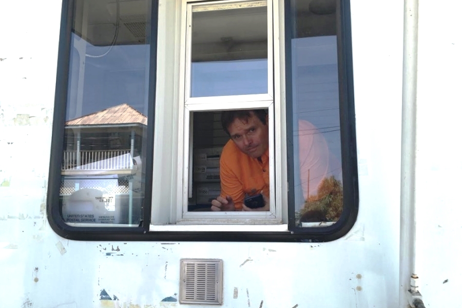 Postmaster Jason Knott stands inside a mobile unit temporarily housing the Cedar Key, FL, Post Office. Image: WUFT