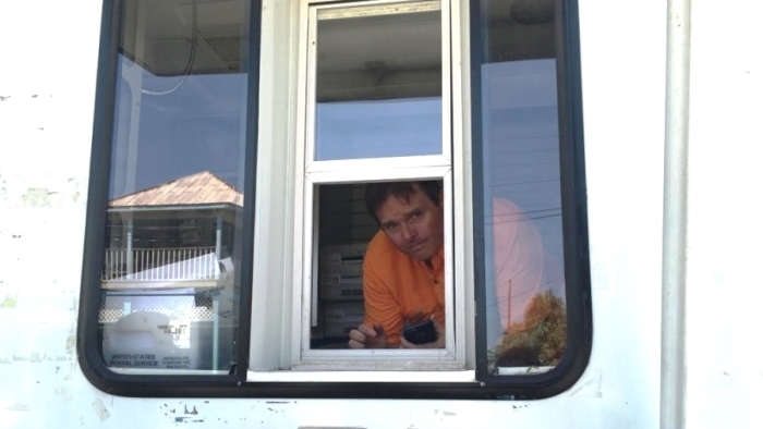 Postmaster Jason Knott stands inside a mobile unit temporarily housing the Cedar Key, FL, Post Office. Image: WUFT