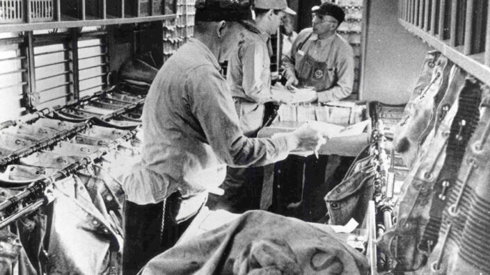 Clerks sort mail in the cramped interior of a Railway Post Office, which typically ranged from 15-60 feet long to about 9 feet wide.