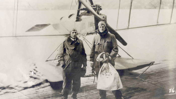 Eddie Hubbard, left, and William E. Boeing stand in front of a Boeing C-700 seaplane near Seattle after returning from a survey flight to Vancouver, BC, in 1919. They brought with them a pouch with 60 letters, making this the first international mail flight.