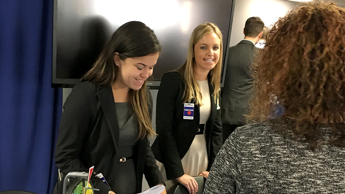 CyberSafe at USPS team members Karina Eldredge and Kristen Bensley distribute information to employees at the recent fair.