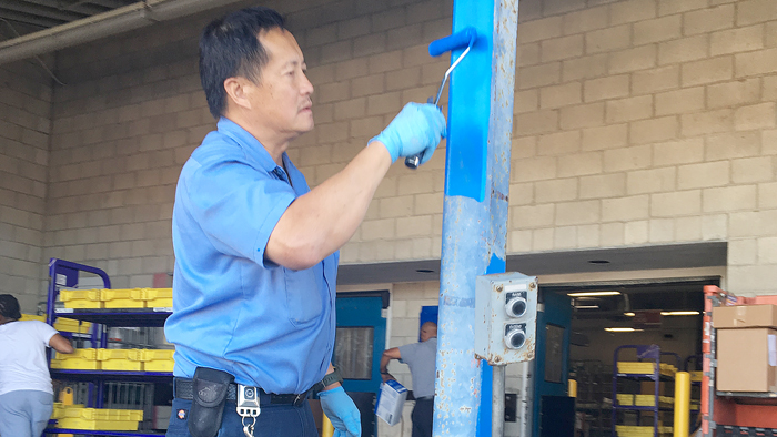 Maintenance Technician Tom Hong paints a dock at Westchester Station in Los Angeles last week.