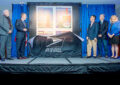 Unveiling the stamp are, from left, Mark Reasoner, president of the American Stamp Dealers Association; Corbett; Low; designer David Spaeth; and USPS Stamp Services Director Mary-Anne Penner.