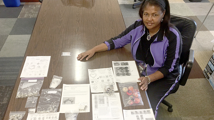 Mail Clerk Kim Wright shows her valuable discovery.