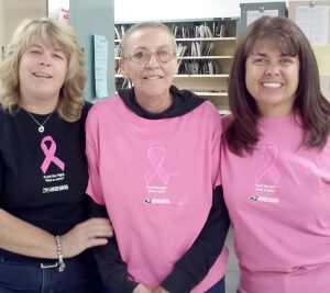 Onondaga, MI, Rural Carrier Peggy Clark, center, who is finishing treatment for breast cancer, celebrates with Postmaster Dawn Kibbey, left, and Rural Carrier Irene Lundy.