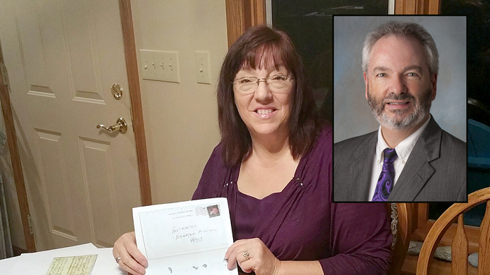 Postmaster Lori Boes displays a copy of the envelope she received containing the Civil War era letters. Stephen Kochersperger, a USPS senior research analyst who helped solve the mystery surrounding the letters, is shown in the inset image.