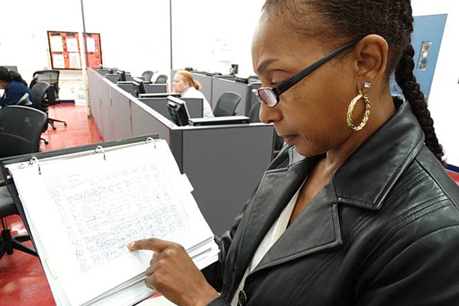 Sarita Montgomery, a Northern Ohio District Election Mail coordinator, checks an Election Mail log earlier this year.
