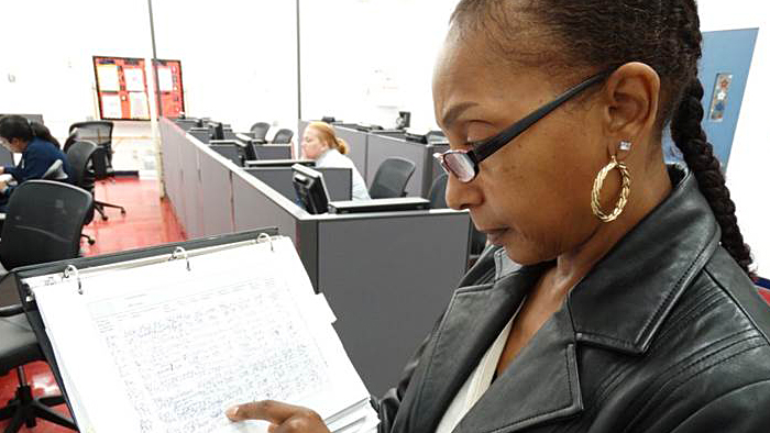 Sarita Montgomery, a Northern Ohio District Election Mail coordinator, checks an Election Mail log earlier this year.