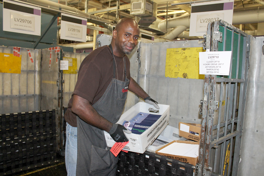 Ray Robinson, a mail handler at the Charlotte, NC, Processing and Distribution Center, loads Political Mail last month.
