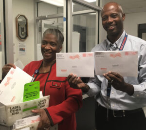 In Charlotte, NC, distribution operations managers Crystal Hutchins-Jones and Jeff McClure accept the last batch of this year’s absentee ballots before the state deadline.