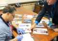 Lake Geneva, WI, Retail Associate Ken Dillingham and Postmaster Steve Saylor review the office’s political mail log.