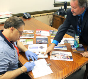 Lake Geneva, WI, Retail Associate Ken Dillingham and Postmaster Steve Saylor review the office’s political mail log.
