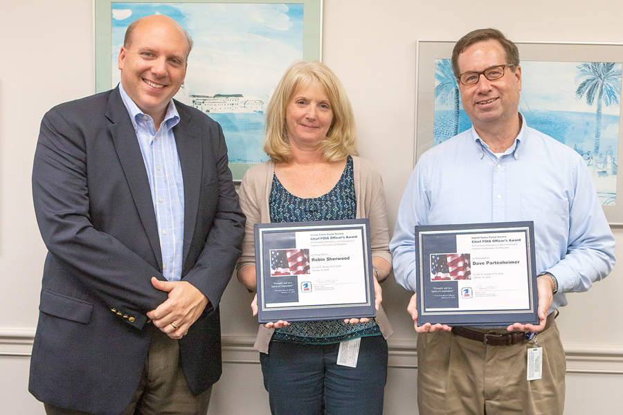 Associate General Counsel and Chief Ethics and Compliance Officer Michael J. Elston poses with headquarters honorees Robin Sherwood, a budget and cost analyst, and David Partenheimer, a media relations manager.