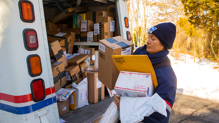 It’s shaping up to be another busy holiday season for employees like Alexandria, VA, Letter Carrier Cruz Rivera, shown making deliveries earlier this year.