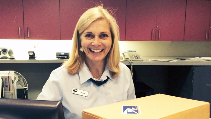 Providence, RI, Retail Associate Jean McCormick accepts a holiday package in December 2014.