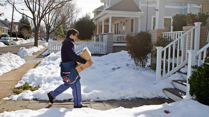 Alexandria, VA, Letter Carrier Teck Hong delivers packages. USPS is expecting double-digit increases in holiday parcel deliveries this year.