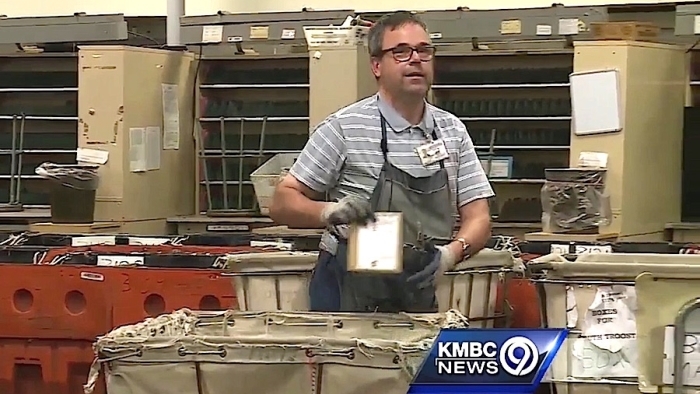 Kansas City, MO, Retail Associate John Bryde handles a package before his retirement. Image: KMBC