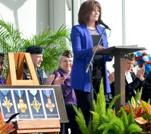 St. Louis Postmaster Cathy Vaughn leads a special dedication of the Honoring Extraordinary Heroism: The Service Cross Medals stamps.