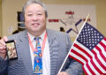 Peter Wong, a Marine Corps’ retired sergeant and the customer services manager at the Jamaica, NY, station, displays his patriotic spirit at a USPS ceremony.