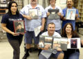 Veterans at the Rohnert Park, CA, Post Office display phots of themselves during their military careers. Standing, from left, are Postmaster Celestina Buckley; Tom Jones and Dolores Wilson-Condon, letter carriers; and Claro Efe, distribution clerk. Kneeling are Lario Cortex and Robin Walker, letter carriers.