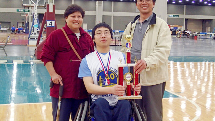 El Cerrito, CA, Letter Carrier David Luong and his wife, Hue, pose with their son, William, and one of his basketball trophies.