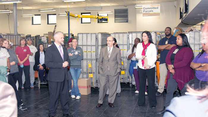 Louisiana District Manager Steve Hardin and Southern Area VP Shaun Mossman, center, welcome Denham Springs employees back to the facility.