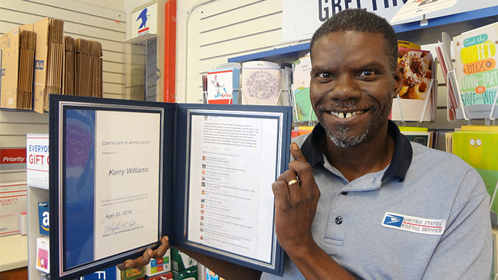 Nashville, TN, Retail Associate Kerry Williams displays a certificate of appreciation he received this year after customers praised him on social media.