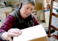 Cambridge, MD, Rural Carrier Ashlie Thorsteinsson loads a delivery vehicle with packages.