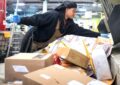 Jaadell Clayton, a clerk at the Omaha, NE, Processing and Distribution Center, helps sort parcels. Image: Omaha World-Herald