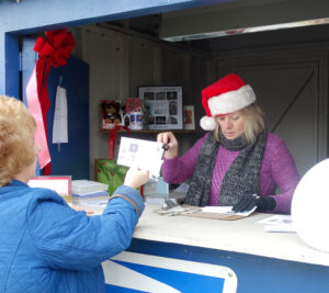 Bethlehem, PA, Retail Associate Tracey Wigg serves customers at a temporary station outside the main Post Office.