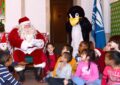 Santa Claus reads to elementary school students at an Operation Santa kickoff at the James A. Farley Post Office in New York City.