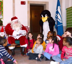 Santa Claus reads to elementary school students at an Operation Santa kickoff at the James A. Farley Post Office in New York City.
