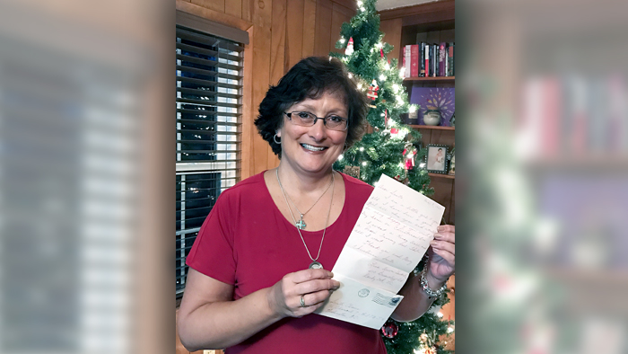 Lisa Buie displays a letter her mother wrote on her behalf in 1964, when Buie was a child. WITN-TV recently reunited Buie with the letter.