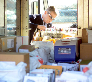 Langhorne, PA, Letter Carrier Hugh French prepares to deliver holiday mail. Image: Bucks County Courier Times