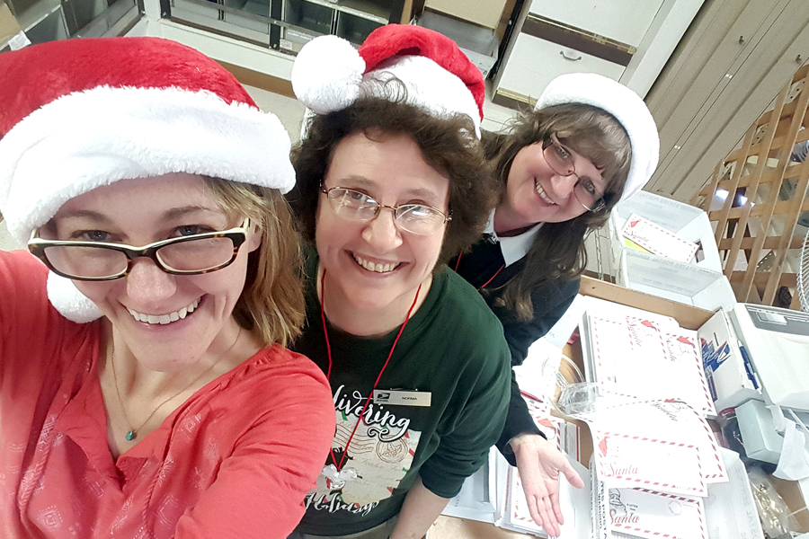 Lake Andes, SD, retail associates Tiffany Stewart and Norma Soulek and Postmaster Tamara Rokusek are all smiles this week as they handle holiday mail.