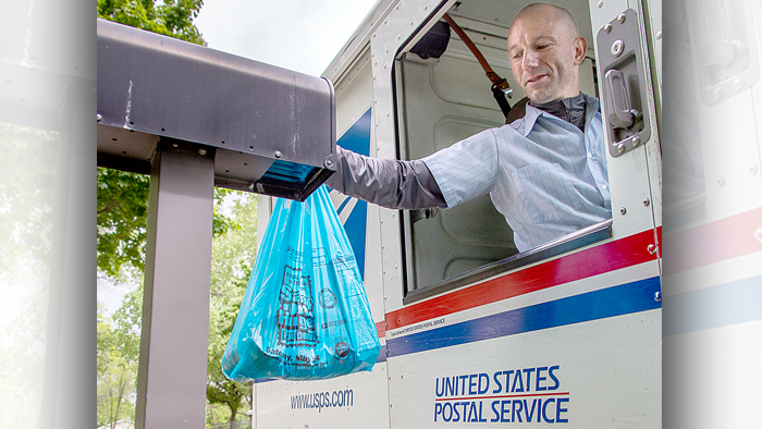 Madison, WI, Letter Carrier Enrico Przygoda collects donations during the Stamp Out Hunger food drive in May.