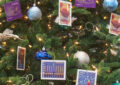 The Christmas tree in DPMG Ronald Stroman’s office is decorated with festive stamp art.