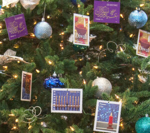 The Christmas tree in DPMG Ronald Stroman’s office is decorated with festive stamp art.
