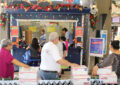 Customers line up for service at Rudolph’s Express Shipping Shack, a festive station at the Honolulu Main Post Office.