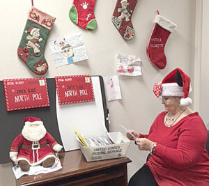 Clerk Sunny Wirth plays the role of Mrs. Claus while answering letters to Santa Claus at the San Antonio, TX, General Mail Facility.