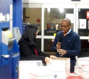 Arlene Sanchez, a Southern Area corporate communications program specialist, gives reporter Larry Collins some holiday shipping tips during a live segment on KXAS-TV in Dallas.
