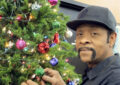 James Spot, a custodian at the Annapolis, MD, Post Office, helps decorate a Christmas tree.