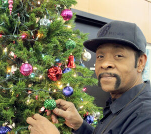 James Spot, a custodian at the Annapolis, MD, Post Office, helps decorate a Christmas tree.