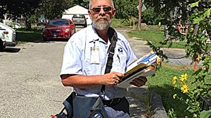 Letter carrier Vernon Moore poses on his route