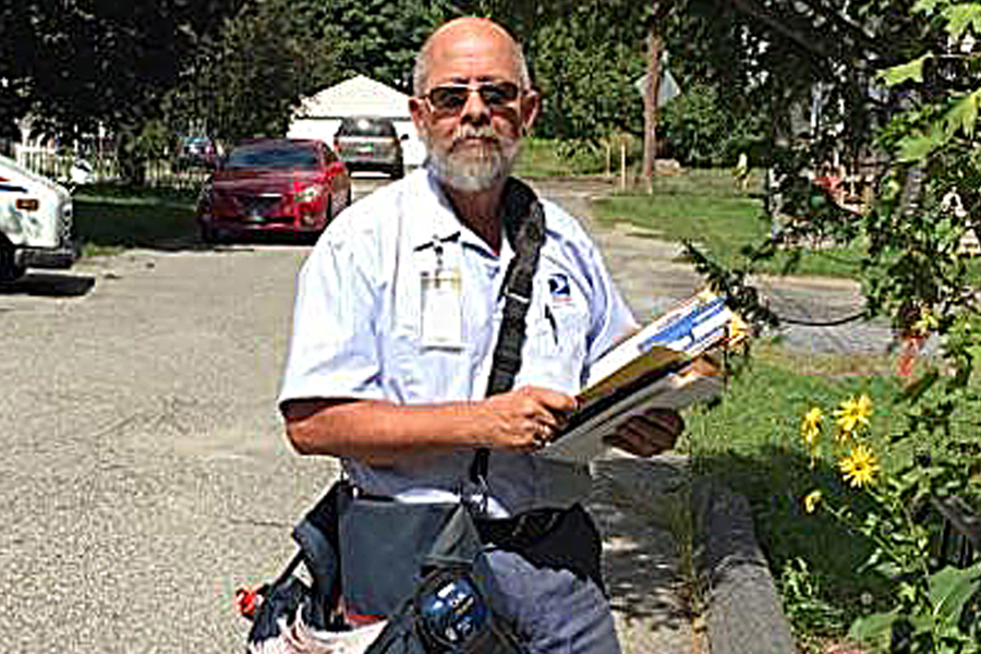 Letter carrier Vernon Moore poses on his route