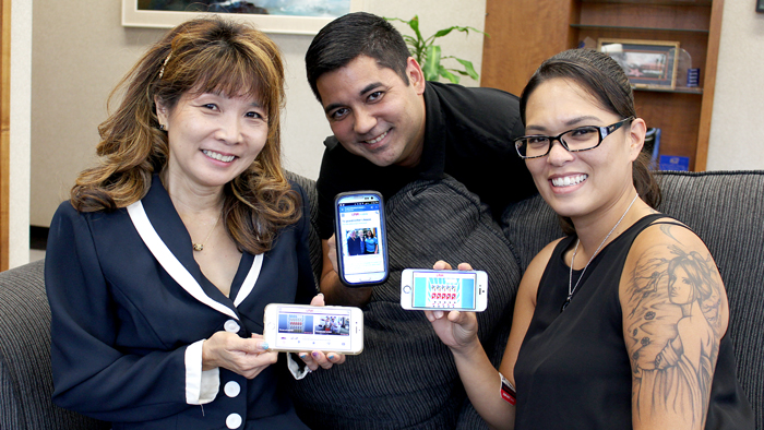 Employees displaying the Link mobile homepage on their smartphones