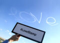 The word “Love” appears in the skies above Chino while Pacific Area Writer/Editor John Hyatt reminds everyone to use the hashtag #LoveStamp to discuss the stamps on social media.